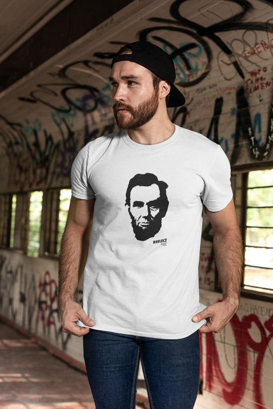 cool bearded man with backwards cap wearing white reelect president Abraham Lincoln unisex t-shirt